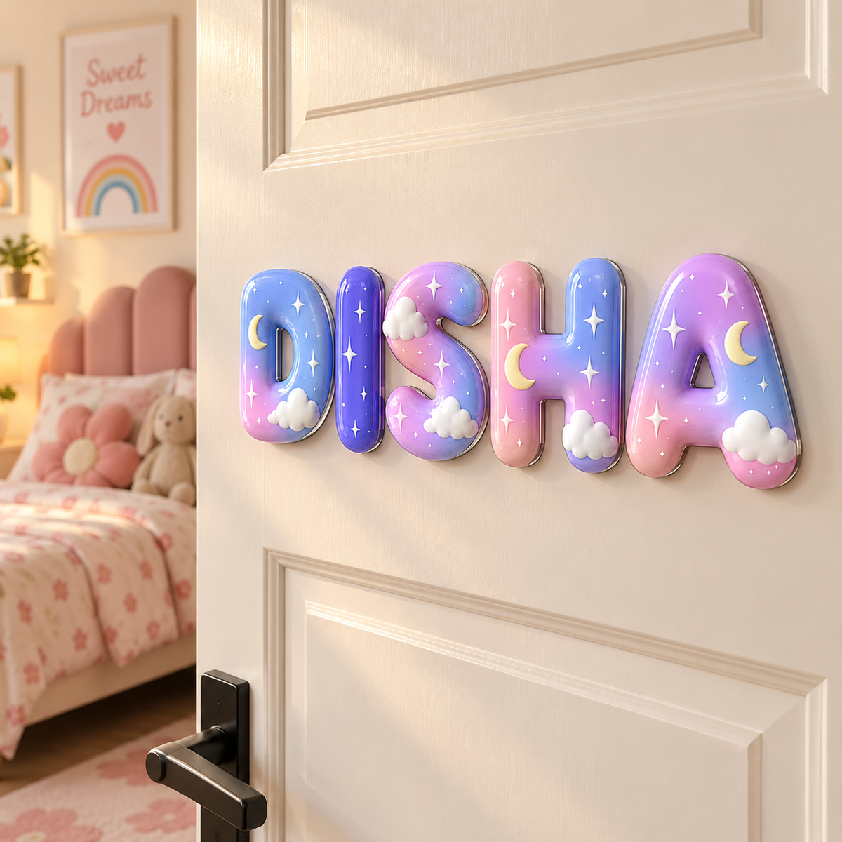 Decorative 3D letters spelling 'DISHA' mounted on a cream-colored door in a child's bedroom. The letters feature a pastel galaxy gradient of blue, purple, and pink, decorated with white clouds and yellow crescent moons and stars.